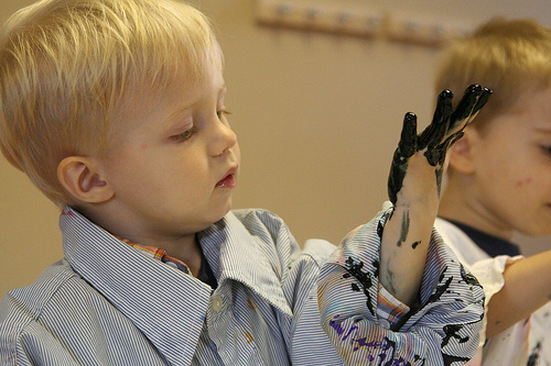 Child finger painting.